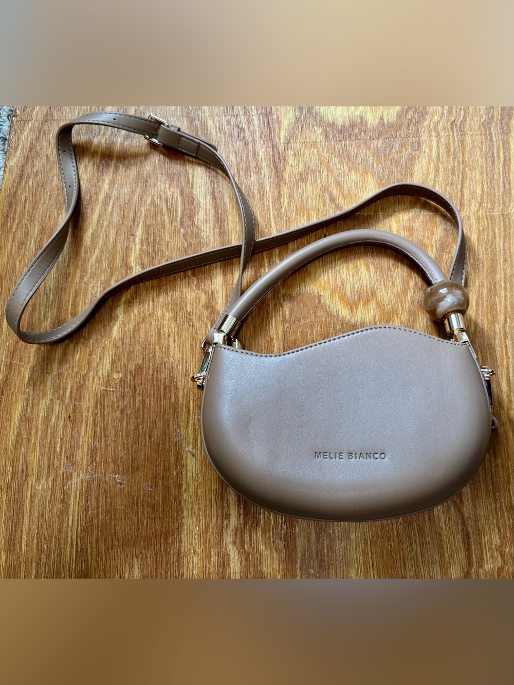 Melie Bianco Taupe Curved Crossbody with Gold Accents